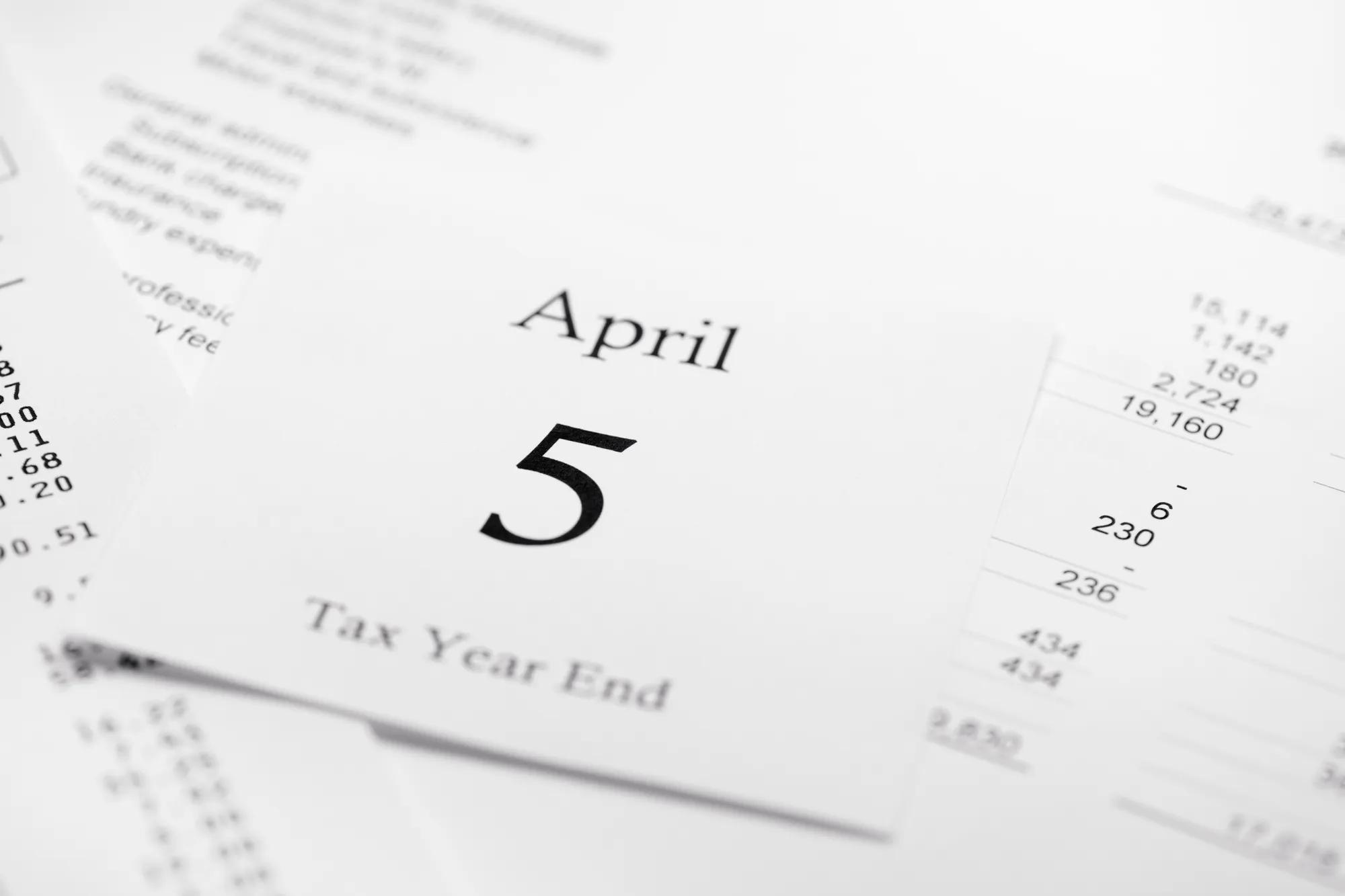 Tax Accounting Year End - April 5th calendar page on background of acounts sheets and financial tables.See also: